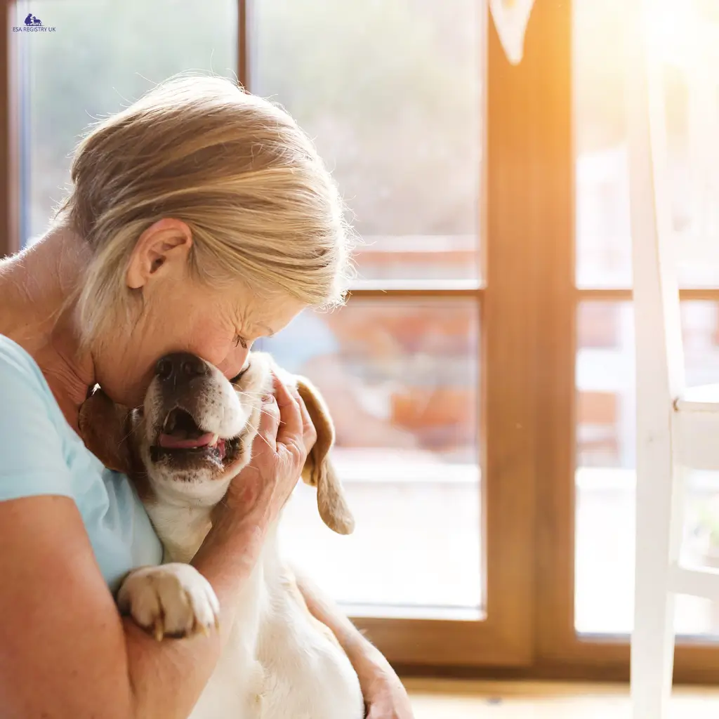 A lady hugging her emotional support dog close to her.