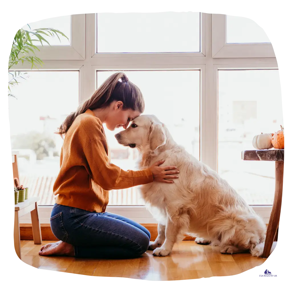 A lady with her emotional support dog, hugging them closely.