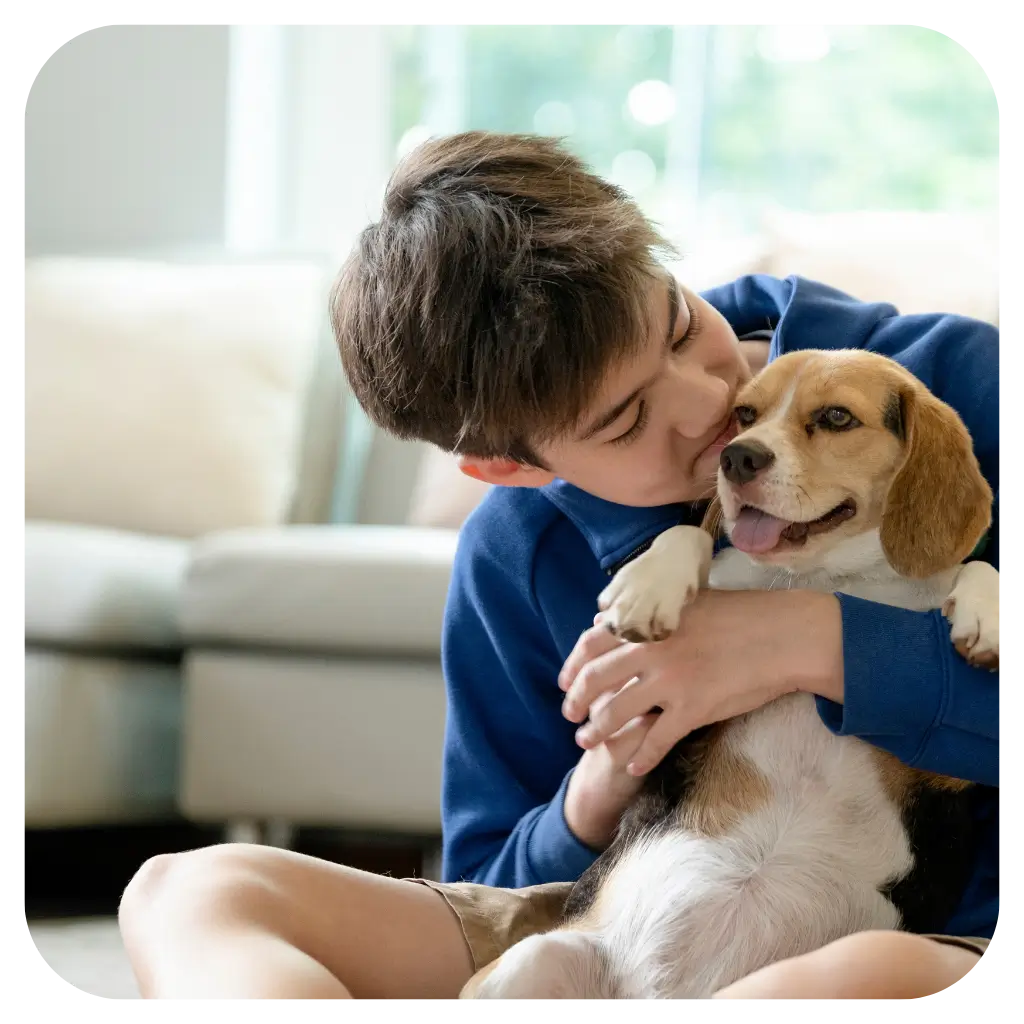 A man cuddling his emotional support dog, after registering them with ESA Registry UK.