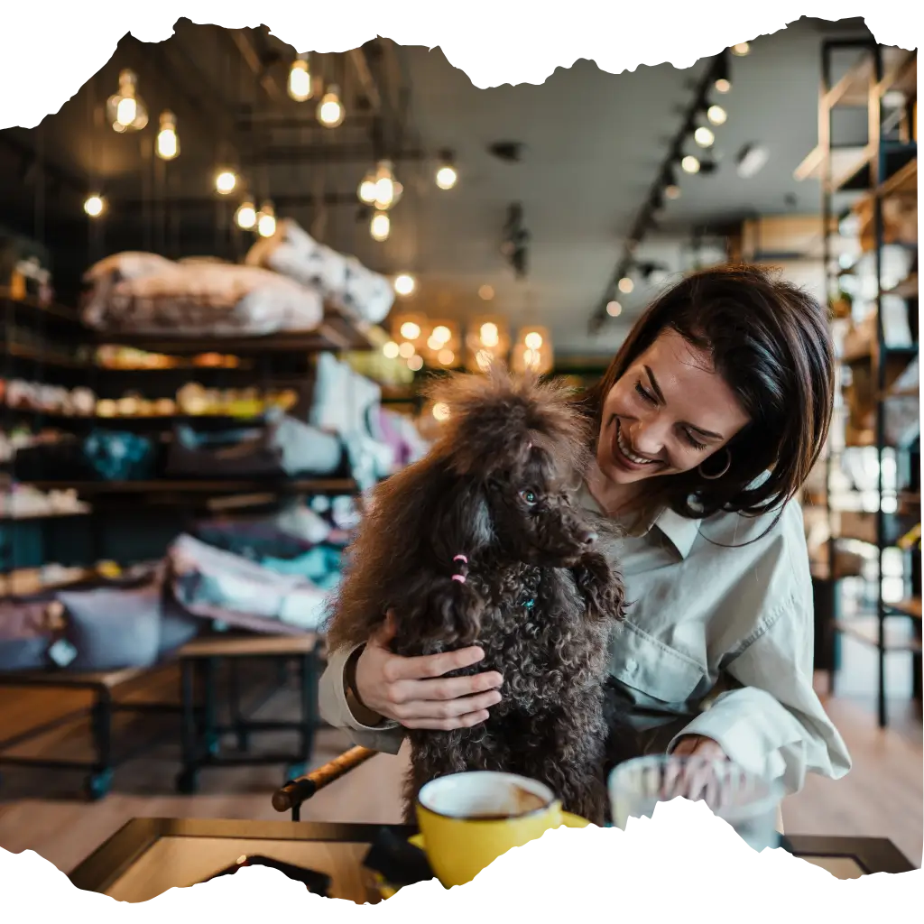 A woman with her emotional support animal after registering her pet with ESA Registry UK in a public space such as cafe