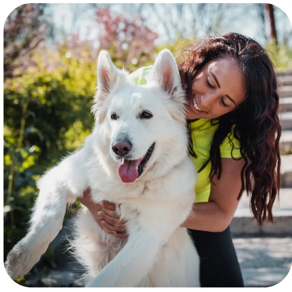 Man and women petting their emotional support dog in a park after registering with ESA Registry UK
